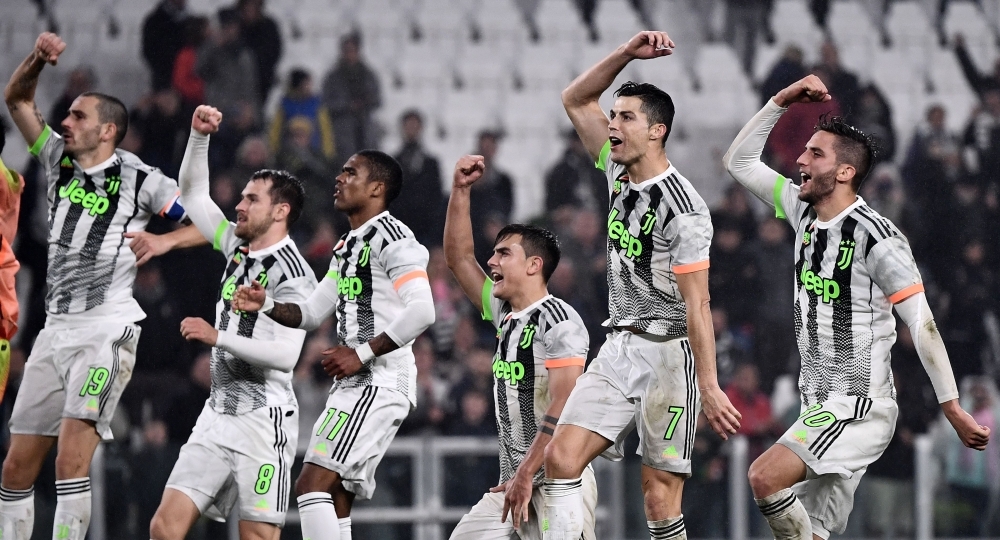 Juventus' Portuguese forward Cristiano Ronaldo (2R) celebrates with his teammates at the end of the Italian Serie A football match between Juventus and Genoa on Wednesday at the 'Allianz Stadium' in Turin. — AFP