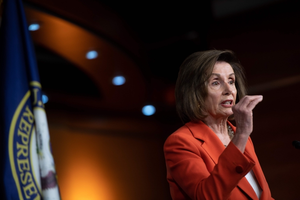 Speaker of the House Nancy Pelosi speaks during her weekly press conference on Capitol Hill in Washington, DC, Thursday. The House Rules Committee agreed by a party line vote to put the impeachment resolution up for approval before the full House of Representatives . — AFP