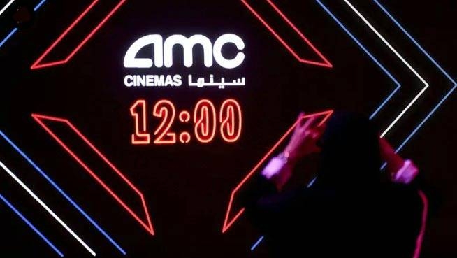 File photo shows a Saudi taking a picture of the AMC logo during a cinema test screening in Riyadh on April 18, 2018. — AFP