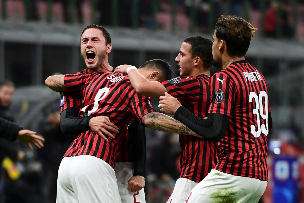 AC Milan's Algerian defender Ismael Bennacer fights for the ball with Spal's Italian midfielder Simone Missiroli during the Italian Serie A football match between AC Milan and Spal on Thursday at the San Siro stadium in Milan. — AFP