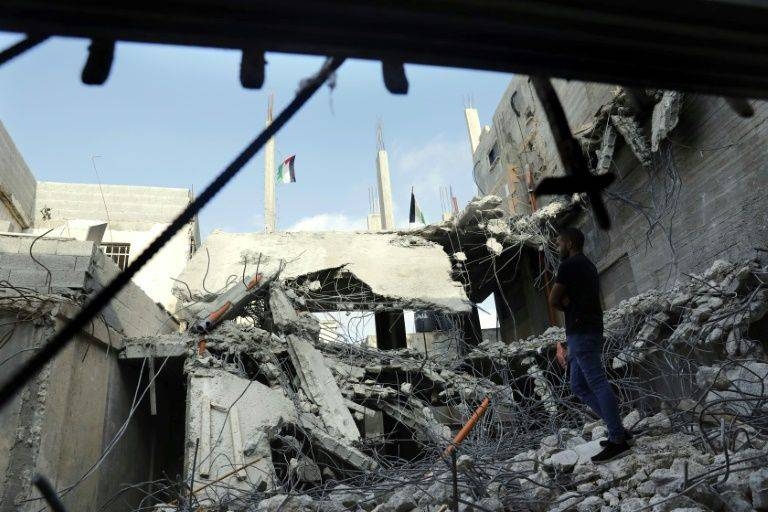 Twisted metal and concrete rubble are all that remain of the family home of Latifa Naji after Israeli forces demolished it in October, the fourth time it has been razed as punishment for attacks carried out by her sons. — AFP