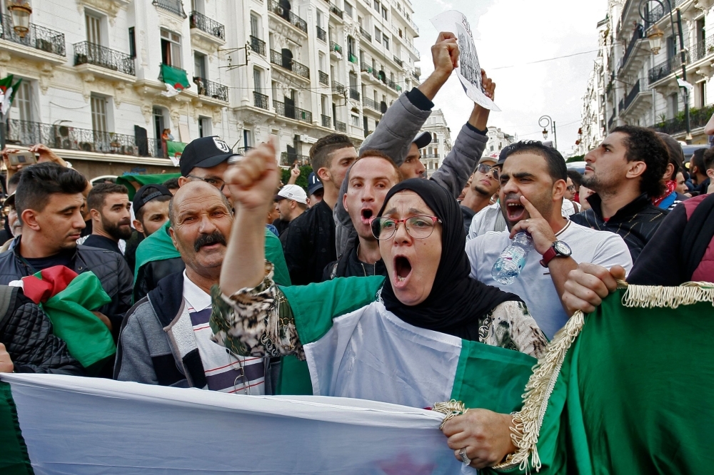 Algerian protesters chant slogans during anti-government demonstrations in the capital Algiers on Friday. — AFP
