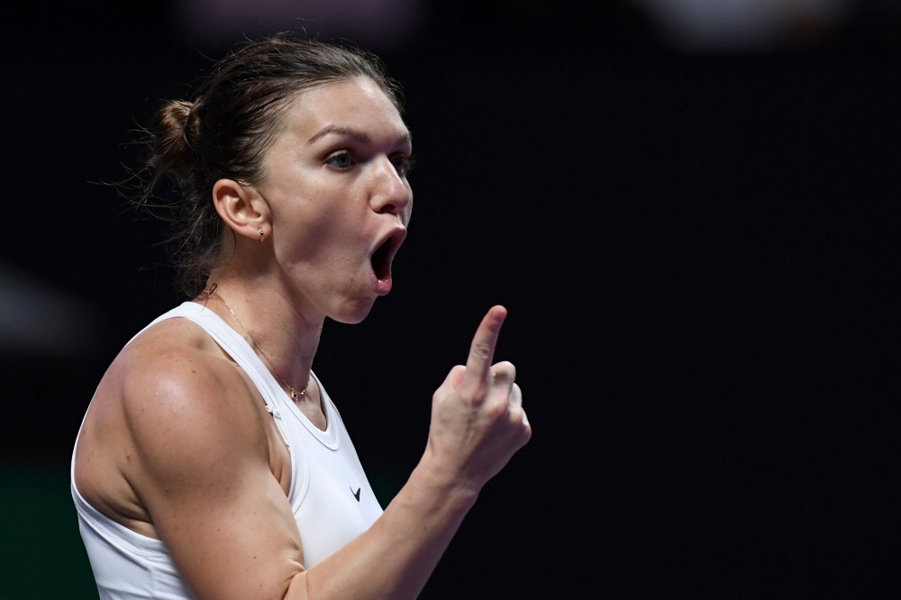 Simona Halep of Romania reacts during her women's singles match against Karolina Pliskova of Czech Republic in the WTA Finals tennis tournament in Shenzhen, on Friday. — AFP