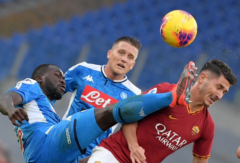 AS Roma's Turkish defender Mert Cetin (R) fights for the ball with Napoli's Senegalese defender Kalidou Koulibaly (L) during the Italian Serie A football match between AS Roma and Napoli at the Olympic stadium in Rome, on Saturday. — AFP