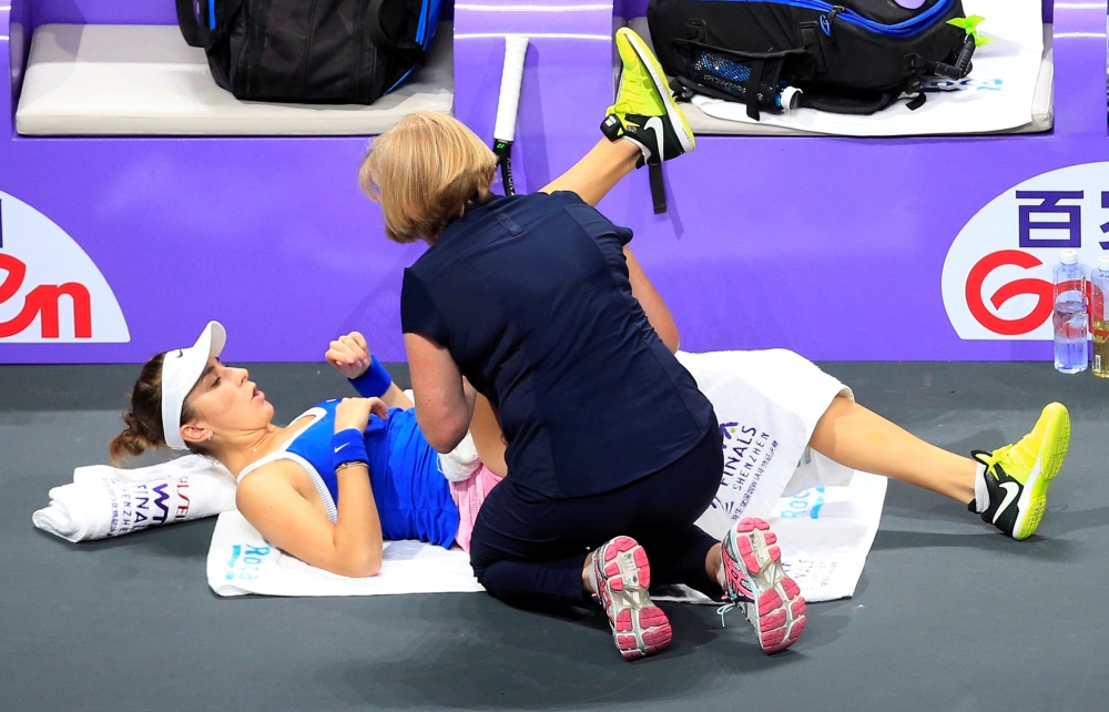 Switzerland's Belinda Bencic receives medical attention during her semifinal match against Ukraine's Elina Svitolina at Shenzhen, Guangdong province, China. — Reuters