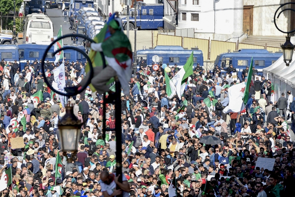 Algerians take part in an anti-government demonstration in the capital Algiers on Friday. -AFP  