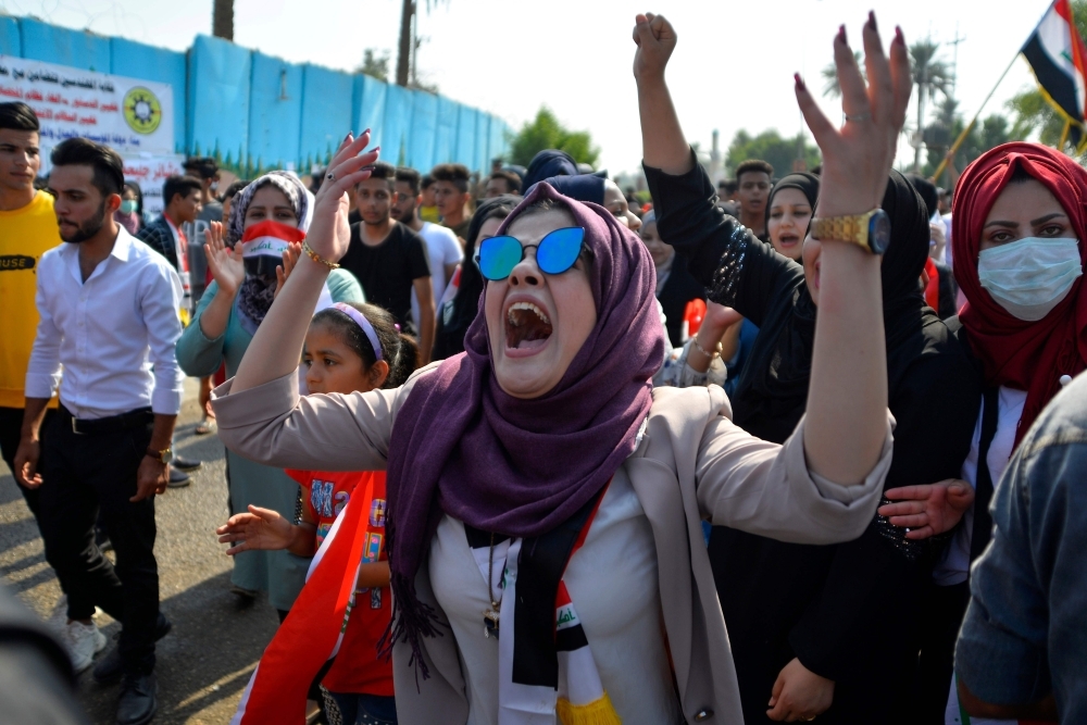 An Iraqi protester shouts slogans during ongoing anti-government demonstrations in the eastern city of Diwaniyah on Sunday. Protesters in Iraq's capital and the country's south shut down streets and government offices in a new campaign of civil disobedience, escalating their month-long movement demanding change to the political system. — AFP