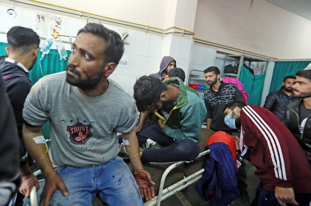  Victims who were injured in a grenade blast are treated at a hospital in Srinagar, on Monday. -Reuters