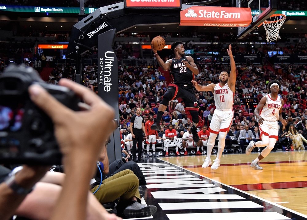 Miami Heat forward Kelly Olynyk (9) is defended by Houston Rockets guard Chris Clemons (3) at the basket during the second half at American Airlines Arena, Miami, FL, USA, on Sunday. — Reuters