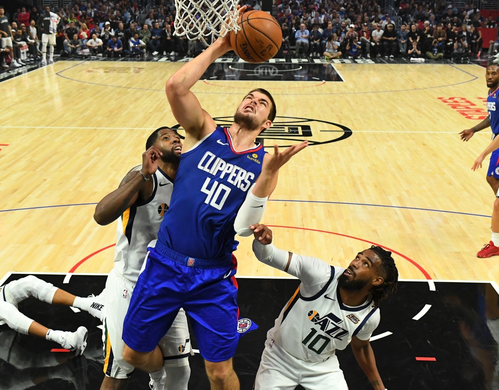 Miami Heat forward Kelly Olynyk (9) is defended by Houston Rockets guard Chris Clemons (3) at the basket during the second half at American Airlines Arena, Miami, FL, USA, on Sunday. — Reuters