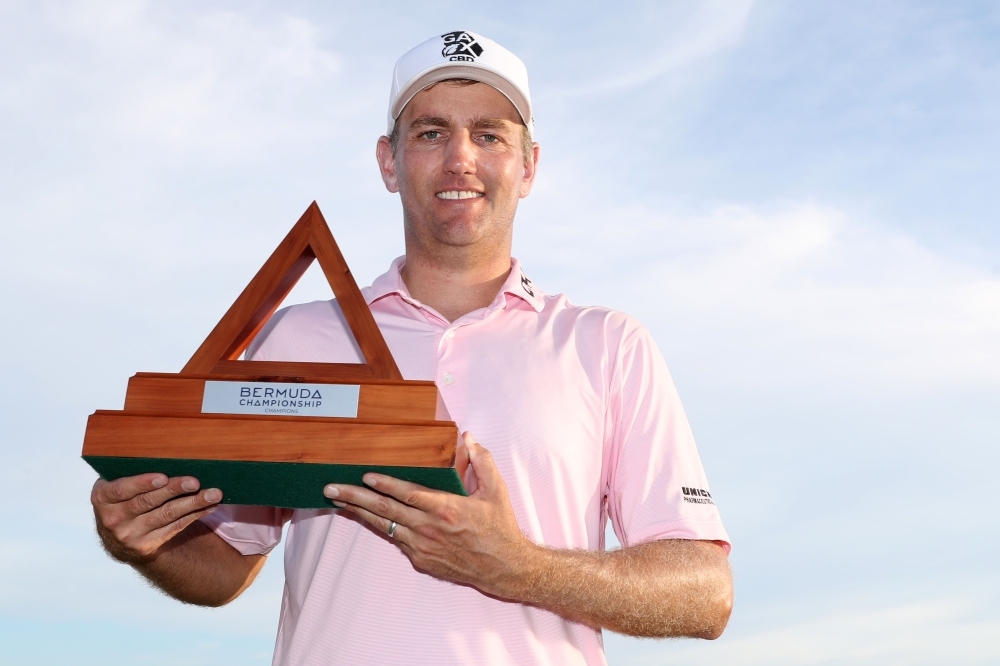 Brendon Todd of the United States celebrates with the trophy after winning the Bermuda Championship at Port Royal Golf Course in Southampton, Bermuda, on Sunday. — AFP