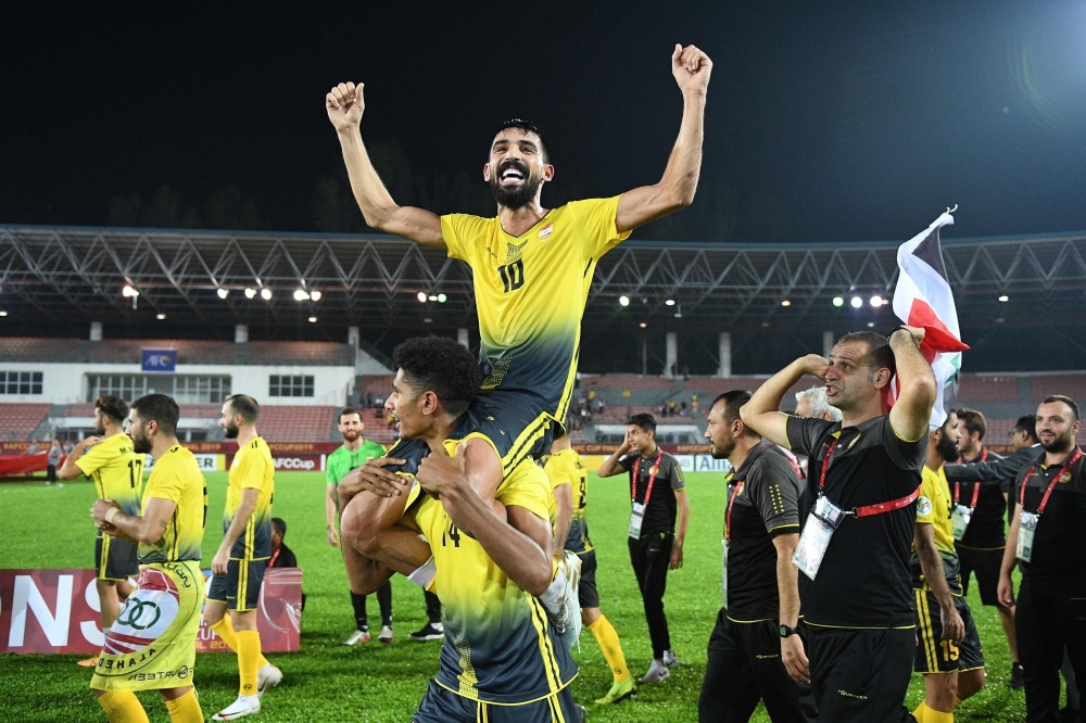 Al Ahed's players and coaching staff celebrate with the trophy after winning the 2019 AFC Cup Final between North Korea's April 25 Sports Club and Lebanon's Al Ahed FC at Kuala Lumpur Stadium in Kuala Lumpur, on Monday. — AFP