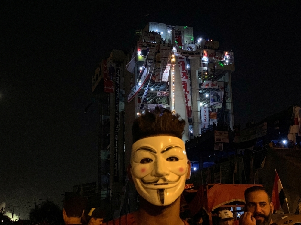 An Iraqi demonstrator wearing a Guy Fawkes mask takes part in one of the ongoing anti-government protests in Baghdad on Monday. -Reuters