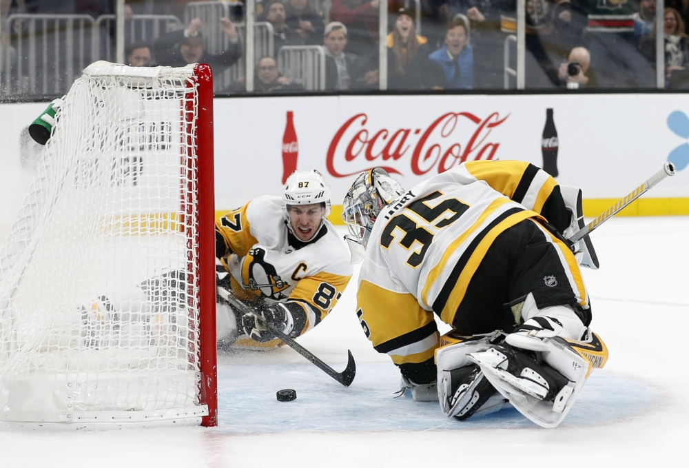 Pittsburgh Penguins center Sidney Crosby (87) and goaltender Tristan Jarry (35) can't stop a puck that bounced off the back of Jerry and into the net for a goal by Boston Bruins center Brad Marchand (63) during the third period of Boston's 6-4 win at TD Garden, Boston, MA, USA, on Monday. — Reuters