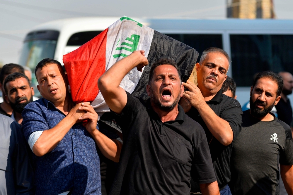 Mourners carry the casket of an Iraqi protester, who was killed the day before in the capital, during his funeral in the central Iraqi city of Najaf, on Tuesday. — AFP