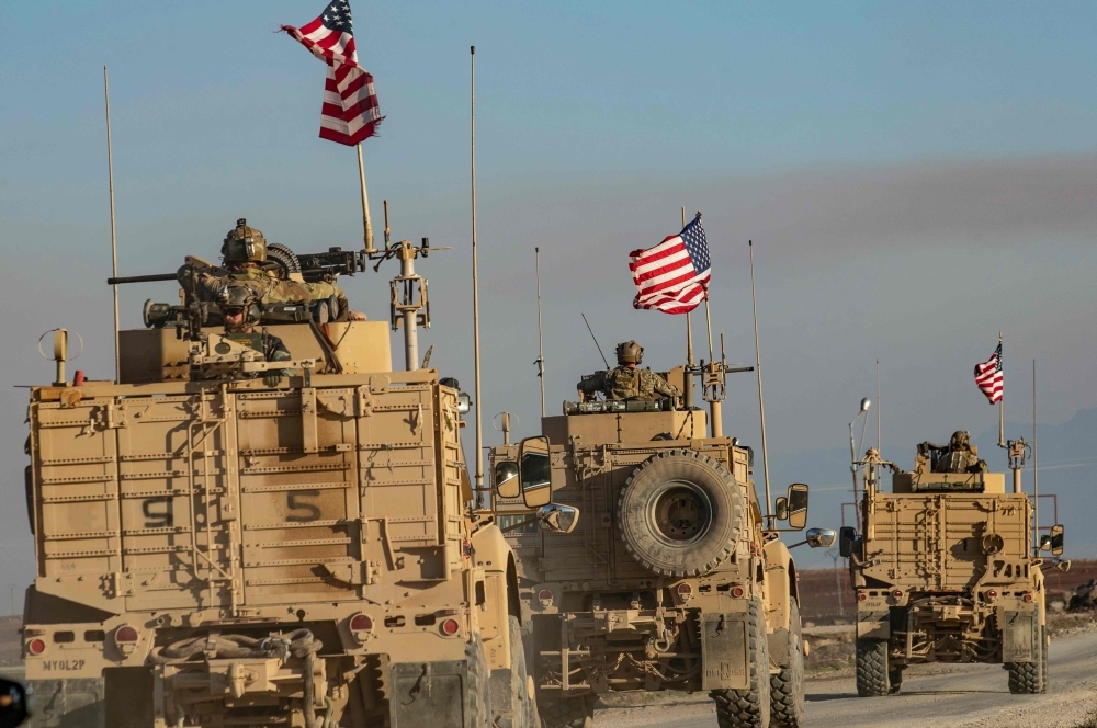 A convoy of US armored vehicles patrols the village of Ein Diwar in Syria's northeastern Hasakeh province on Monday. — AFP