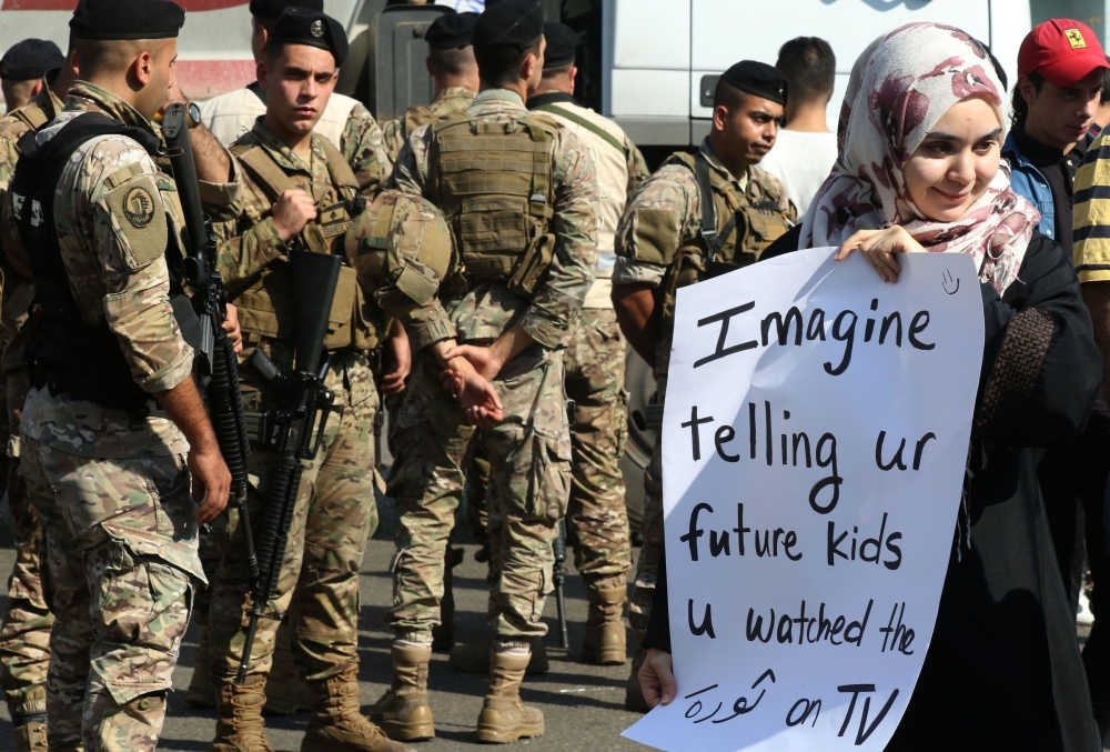 Lebanese school students take part in a protest in the southern city of Sidon (Saida) on Tuesday during ongoing anti-government protests. — AFP