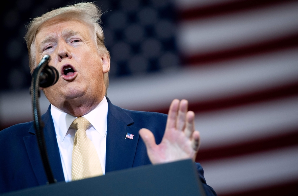 US President Donald Trump gestures as he speaks during a 