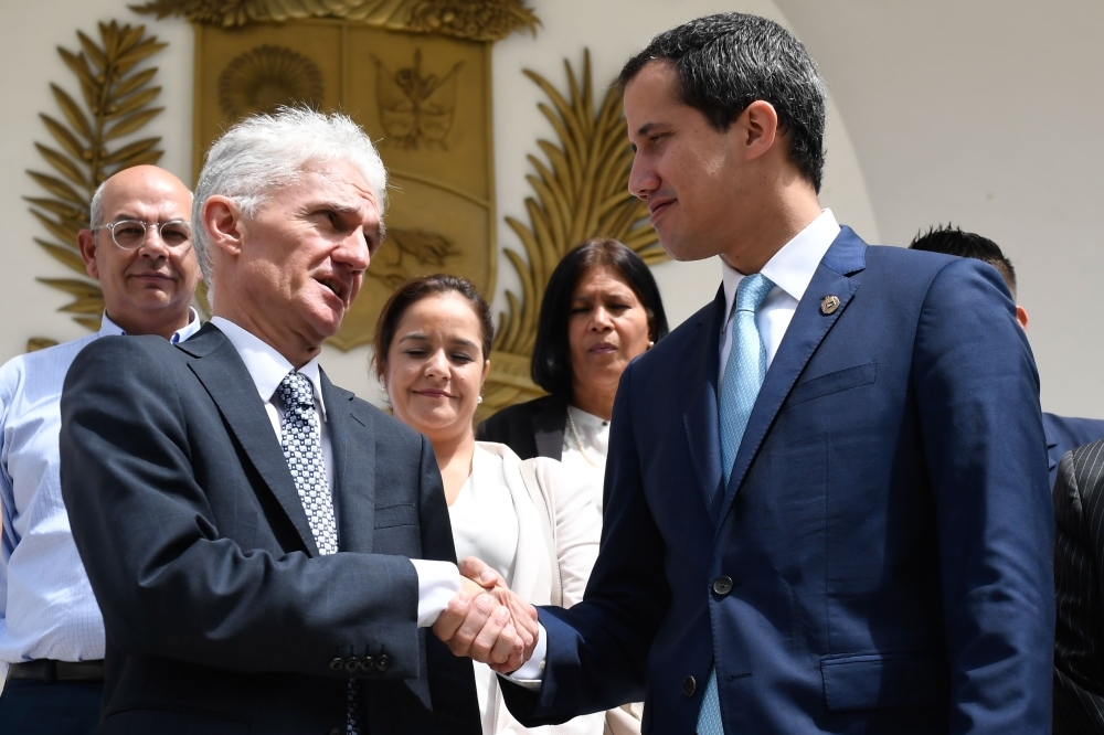 UN Under-Secretary-General for Humanitarian Affairs and Emergency Relief Coordinator Mark Lowcock, left, shakes hands with Venezuelan opposition leader and self-proclaimed acting president Juan Guaido, after holding a meeting at the National Assembly in Caracas, on Tuesday. — AFP