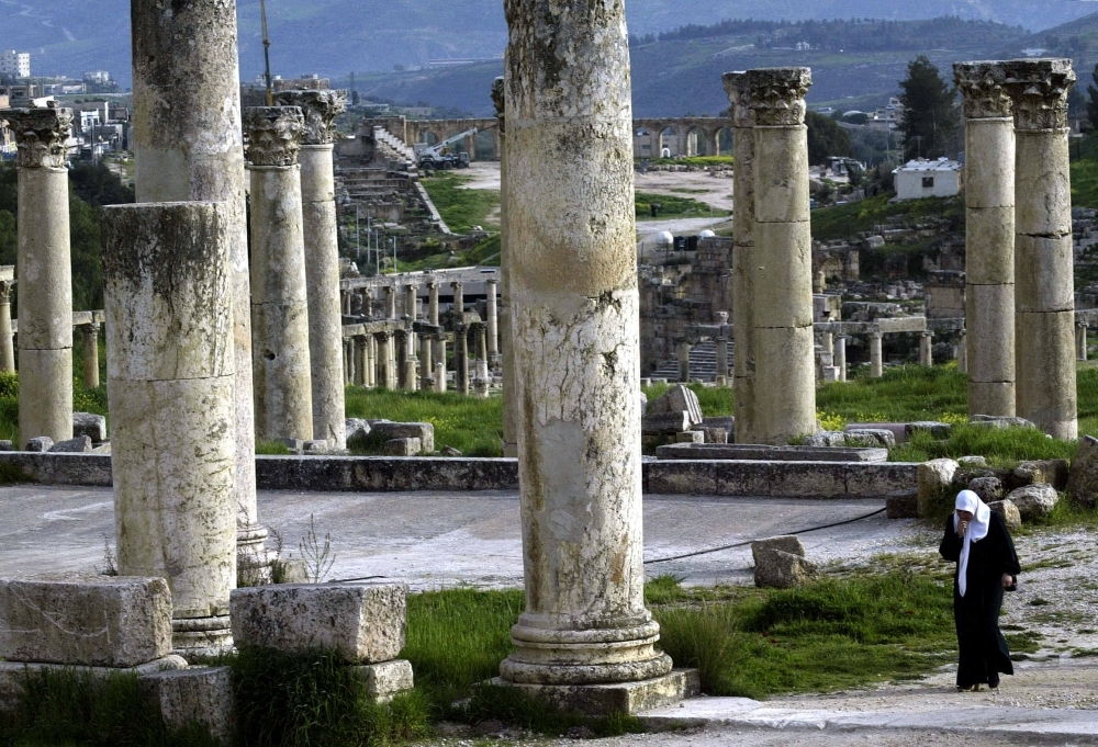  A file photo taken on April 2, 2003 shows a woman walking amid the Roman columns of the ancient city of Jerash, a popular attraction 50 km (30 miles) from the  Jordanian capital Amman. — AFP