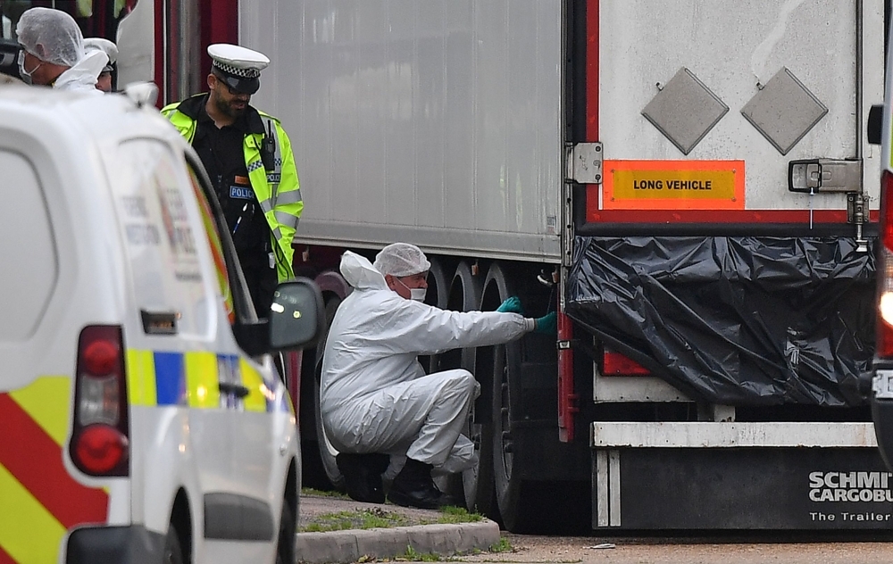 Police forensics officers work on a lorry, found to be containing 39 dead bodies, at Waterglade Industrial Park in Grays, east of London, in this Oct. 23, 2019 file photo. — AFP