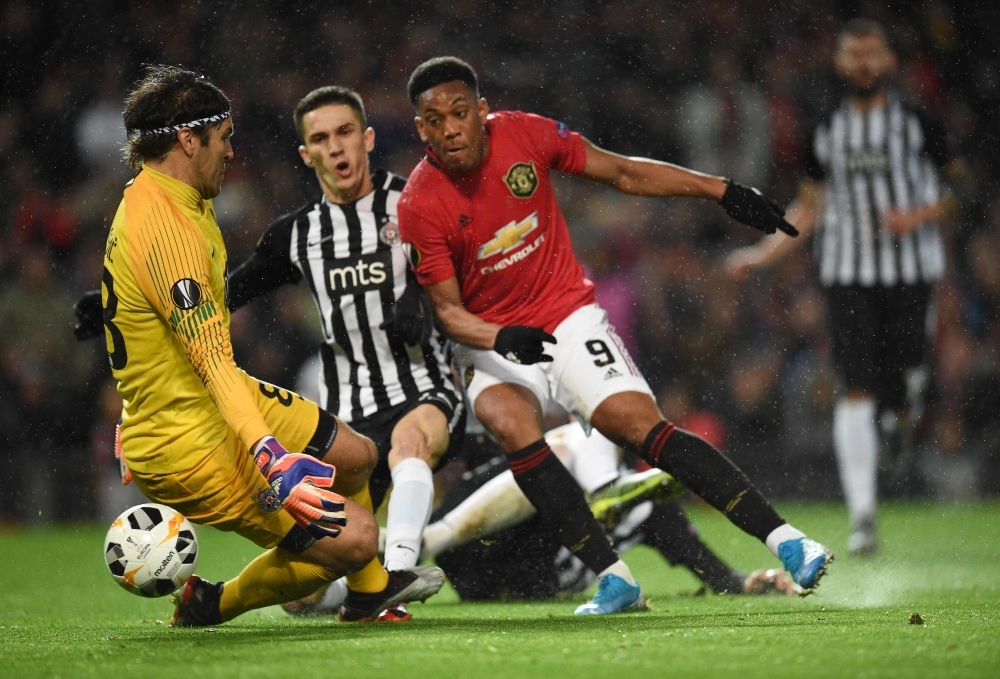 Manchester United's French striker Anthony Martial (C) shoots to score the second goal past FK Partizan's Serbian goalkeeper Vladimir Stojkovic (L) during the UEFA Europa League Group L football match between Manchester United and Partizan Belgrade at Old Trafford in Manchester, north west England, on Thursday. — AFP