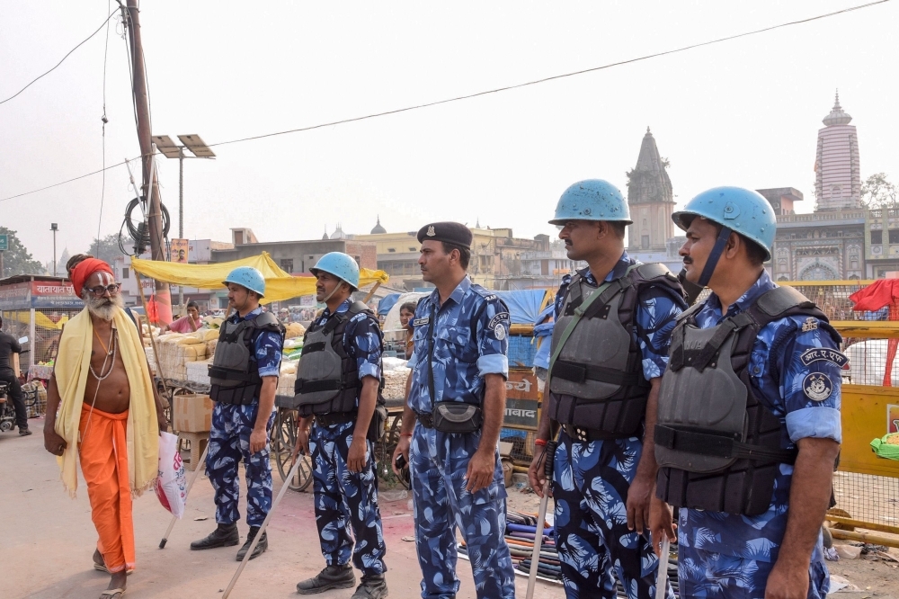 Security personnel stand guard on a street in Ayodhya on Thursday, as part of a security measure ahead of a Supreme Court verdict on disputed 16th-century Babri mosque. — AFP