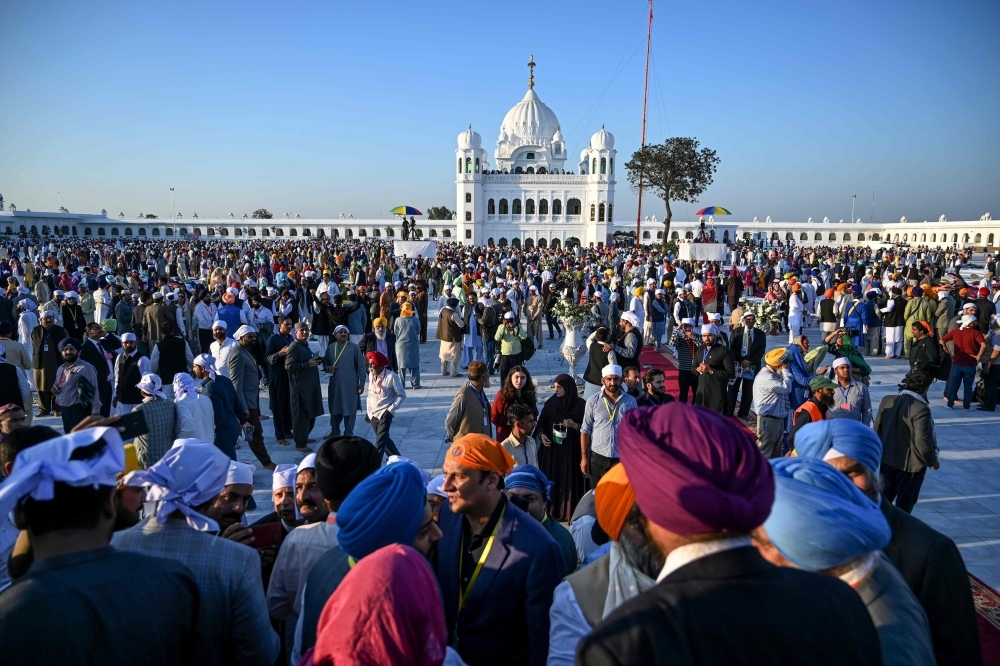 Sikh pilgrims visit the Shrine of Baba Guru Nanak Dev at Gurdwara Darbar Sahib in Kartarpur, near the Indian border, on Saturday. Hundreds of Indian Sikhs made a historic pilgrimage to Pakistan, crossing through a white gate to reach one of their religion's holiest sites, after a landmark deal between the two countries separated by the 1947 partition of the subcontinent. — AFP