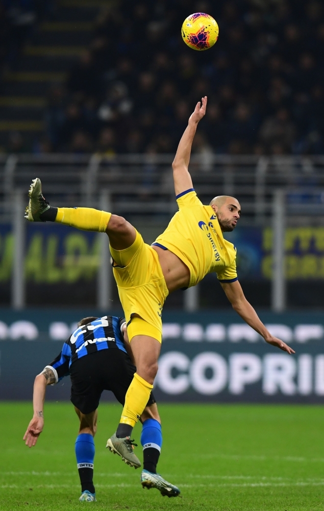 Verona's Brazilian defender Alan Empereur (2ndL) saves a ball during the Italian Serie A football match Inter Milan vs Hellas Verona at the San Siro stadium in Milan on Saturday. — AFP