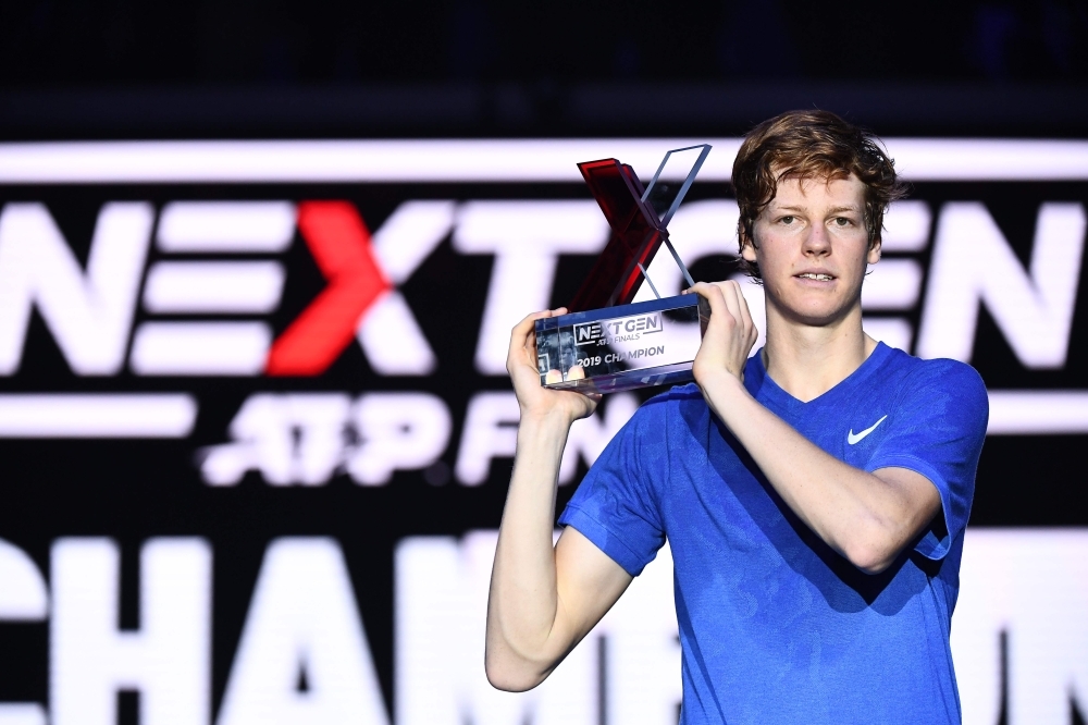 Italy's Jannik Sinner poses with the winner's trophy after defeating Australia's Alex De Minaur during the final of the Next Generation ATP Finals at the Allianz Cloud Court in Milan on Saturday. — AFP