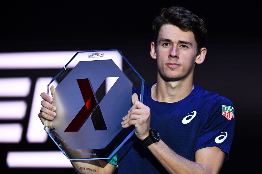 Italy's Jannik Sinner poses with the winner's trophy after defeating Australia's Alex De Minaur during the final of the Next Generation ATP Finals at the Allianz Cloud Court in Milan on Saturday. — AFP