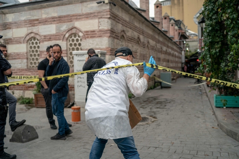 A Turkish police officer arrives at the scene of the Mayday Rescue offices in the Karakoy district of Istanbul, following the discovery of the body of the organization's founder on Monday. — AFP