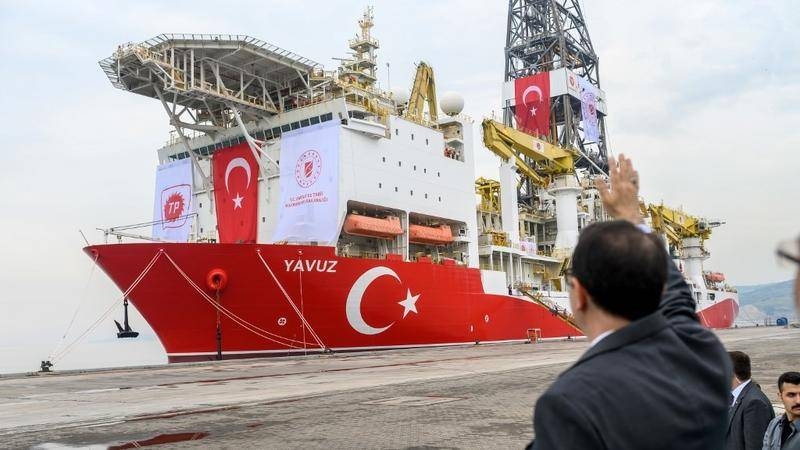 Turkish Energy and Natural Resources Minister Fatih Donmez waves to the drilling ship 'Yavuz' scheduled to search for oil and gas off Cyprus at the port of Dilovasi, outside Istanbul, in this June 20, 2019 file photo. — AFP