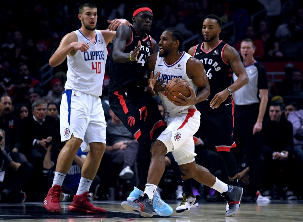 Kawhi Leonard (2) of the LA Clippers bumps into Pascal Siakam (43) of the Toronto Raptors as he drives to the basket as Ivica Zubac (40) and Norman Powell (24) look on during a 98-88 Clippers win at Staples Center in Los Angeles, California on Monday.  — AFP