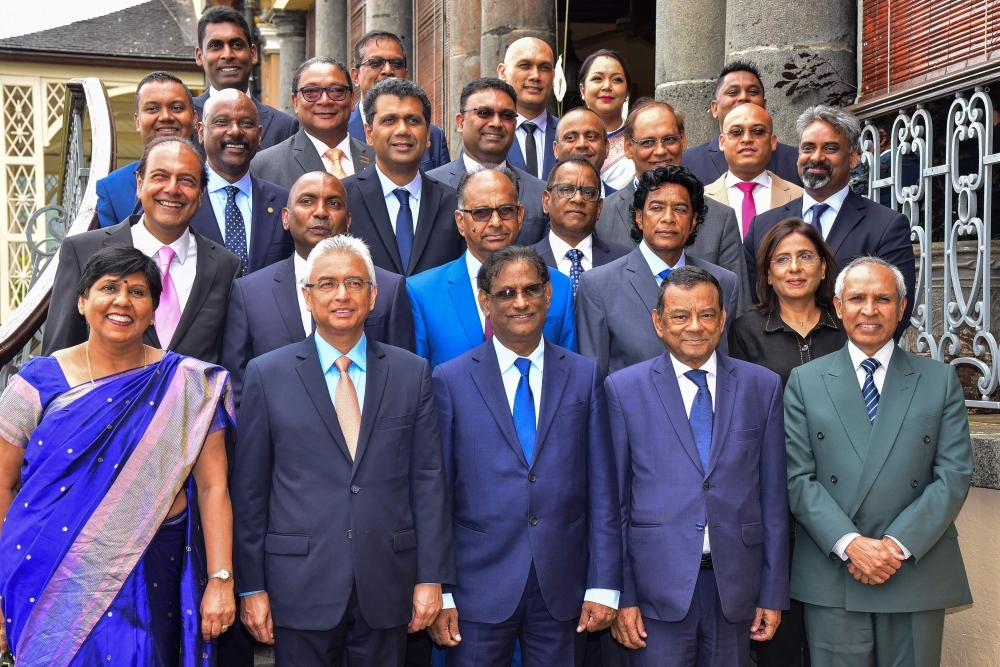 Mauritius’ re-elected Prime Minister Pravind Jugnauth, front, second left, poses with President Barlen Vyapoory, front, center, and his Cabinet after his swearing-in ceremony at the state house in Reduit on Tuesday. — AFP