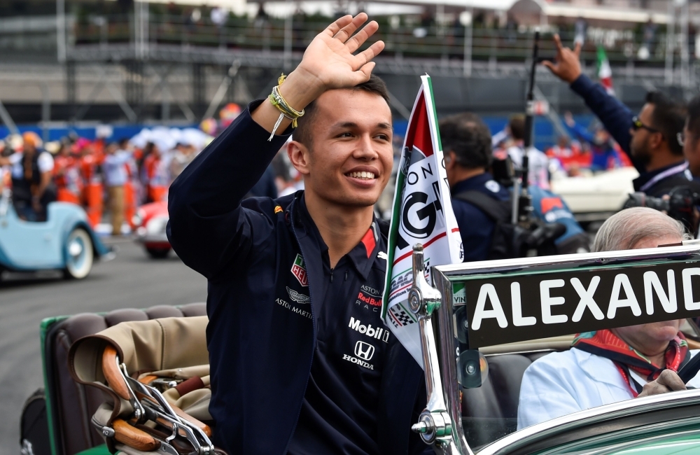 In this file photo taken on Oct. 27, 2019, Red Bull's Thai driver Alexander Albon waves to fans during the drivers' parade prior to the start of the F1 Mexico Grand Prix at the Hermanos Rodriguez racetrack in Mexico City on October 27, 2019. Thailand's Alex Albon has been rewarded for a series of impressive performances by being signed up on a permanent basis as Red Bull's second driver for the 2020 campaign the team announced on Tuesday. — AFP