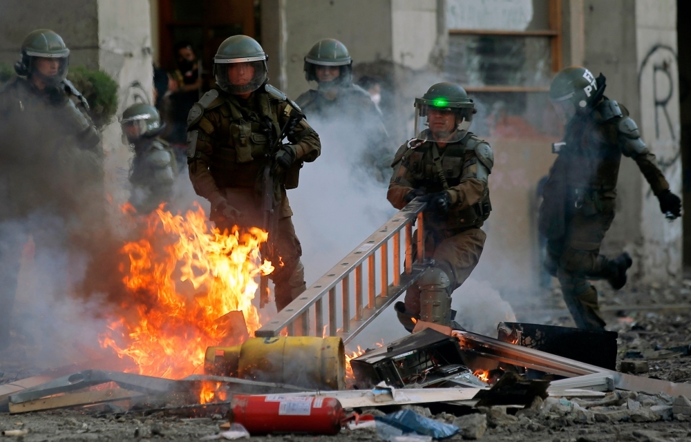 Demonstrators clash with security forces during a protest against the government of Sebastian Pinera in Santiago on Tuesday. -AFP  