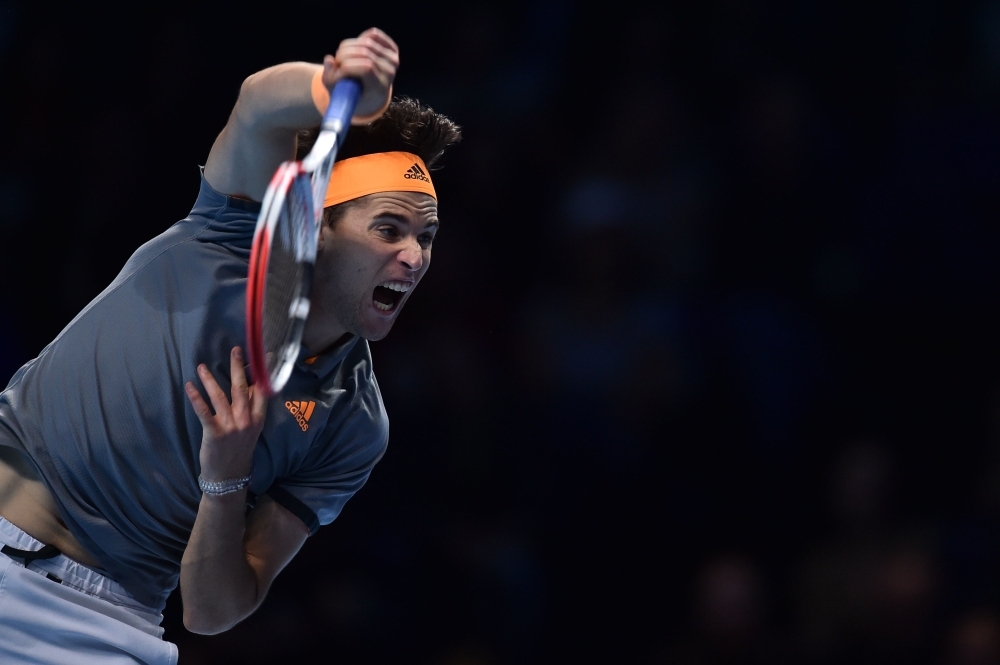 Austria's Dominic Thiem celebrates victory against Serbia's Novak Djokovic during their men's singles round-robin match on day three of the ATP World Tour Finals tennis tournament at the O2 Arena in London on Tuesday. Austria's Dominic Thiem beat Serbia's Novak Djokovic 6-7; 6-3; 7-6. — AFP
