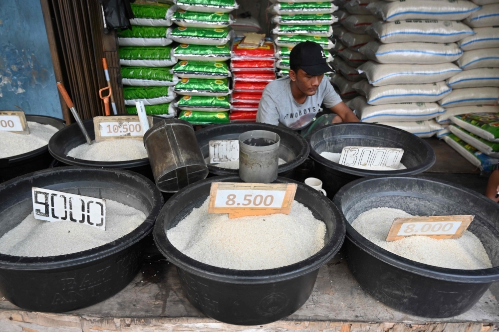 An Indonesian rice seller waits for customers in Jakarta on Wednesday. — AFP