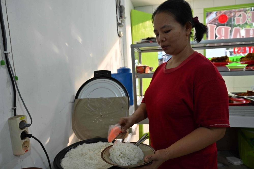 An Indonesian rice seller waits for customers in Jakarta on Wednesday. — AFP