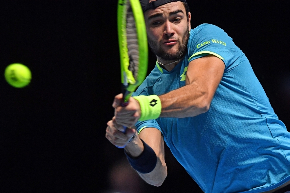 Italy's Matteo Berrettini returns against Austria's Dominic Thiem during their men's singles round-robin match on day five of the ATP World Tour Finals tennis tournament at the O2 Arena in London on Thursday. — AFP