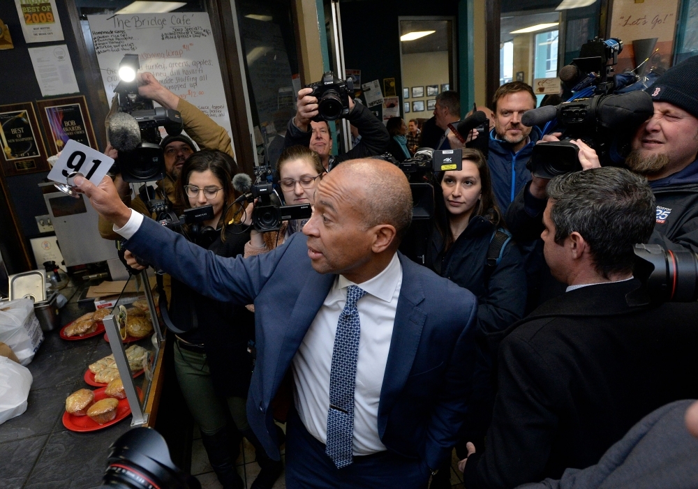 Former Massachusetts Governor Deval Patrick, US Democratic Presidential hopeful, orders lunch and greets locals at the Bridge Cafe on Thursday in Manchester, New Hampshire. — AFP