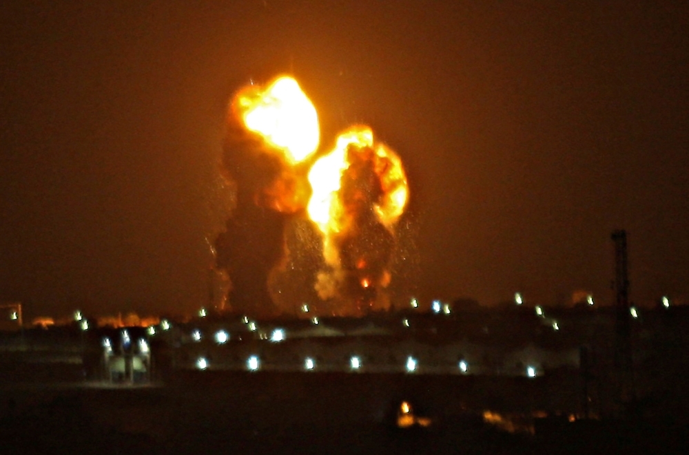 Two balls of fire are seen following an Israel air strike in Khan Yunis in the southern Gaza Strip early on Friday. — AFP