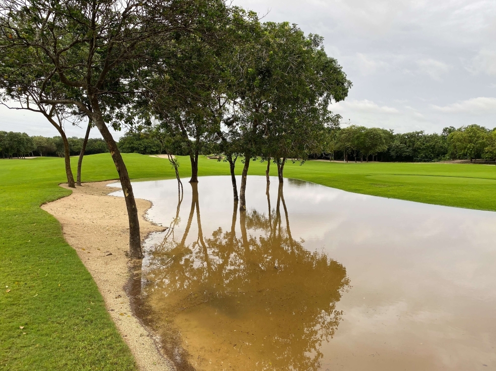 Rain water collects in waste areas around the seventh and ninth holes during a delay in play prior to the first round of the Mayakoba Golf Classic at El Camaleon Mayakoba Golf Course on Thursday in Playa del Carmen, Mexico. — AFP