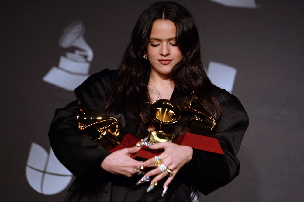 Puerto Rican singer Kany Garcia poses in the press room with the awards for 