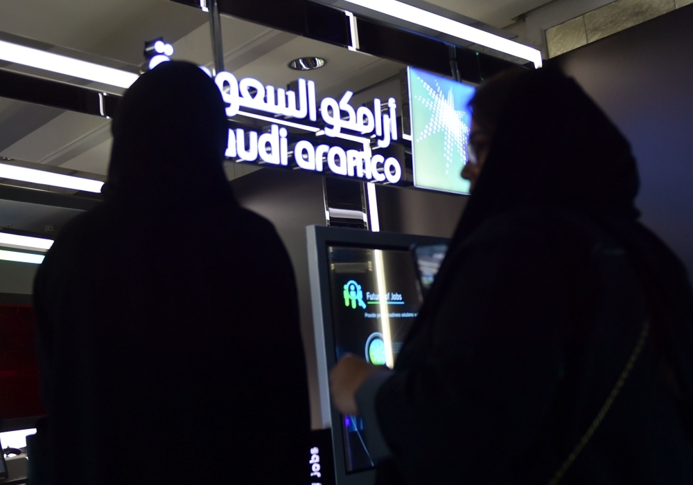 Visitors stop at the Aramco exhibition section at the Misk Global Forum on innovation and technology held in Riyadh on November 13, 2019. (AFP)
