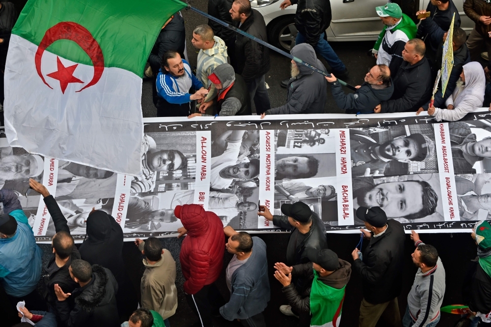 Algerian protesters rally to reiterate their opposition to a presidential election in Algiers on Friday. — AFP