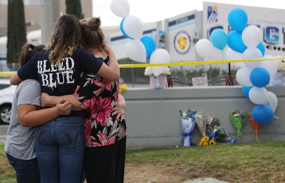 Flowers are placed at a makeshift memorial at Central Park on Friday in Santa Clarita, California, not far from Saugus High School, where parents and children were reunited following the school shooting a day earlier. — AFP