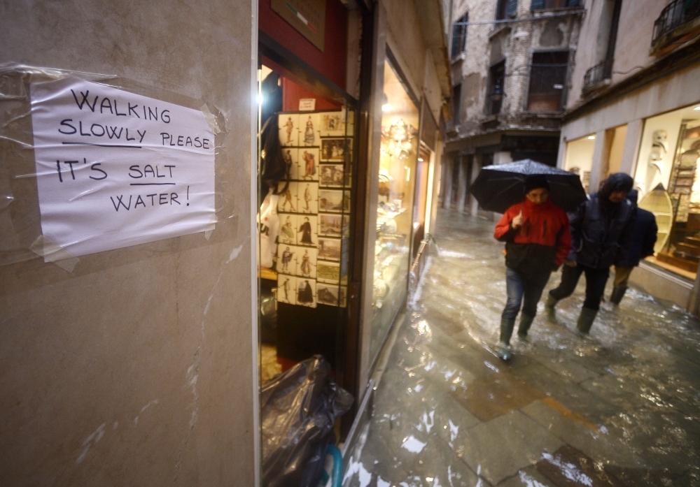 A general view shows the flooded St. Mark's Square, with St. Mark's Basilica (Rear L) and the Bell Tower on Saturday in Venice, two days after the city suffered its highest tide in 50 years. — AFP