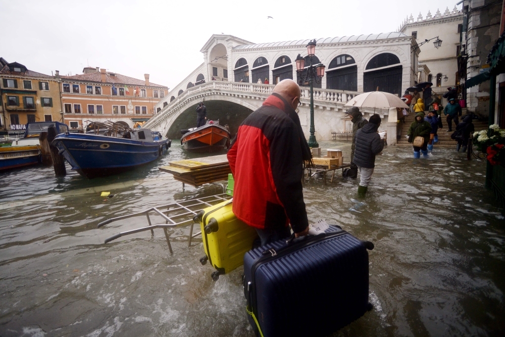 A general view shows the flooded St. Mark's Square, with St. Mark's Basilica (Rear L) and the Bell Tower on Saturday in Venice, two days after the city suffered its highest tide in 50 years. — AFP